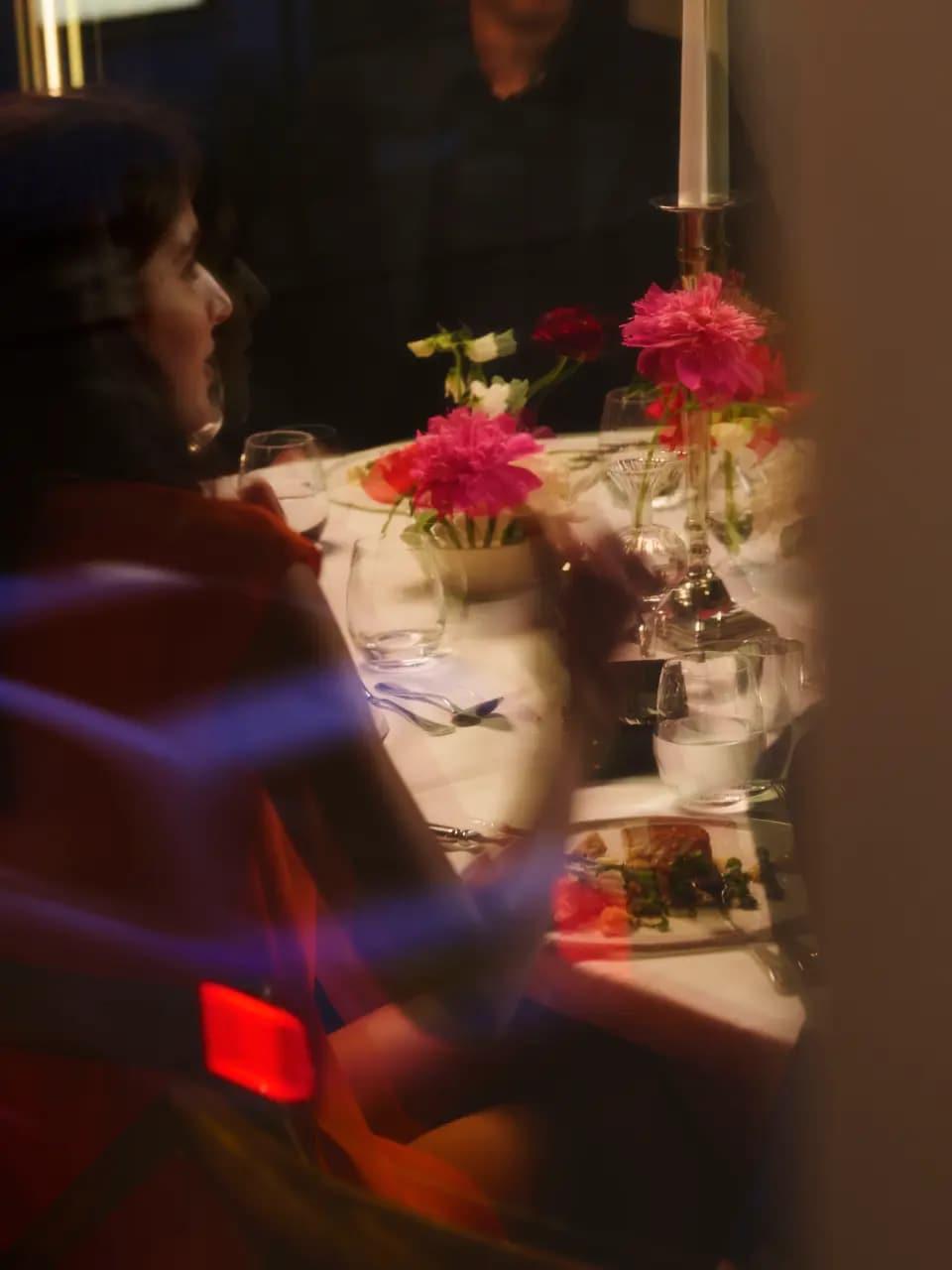 An intimate dining table with fresh flowers and candlelight